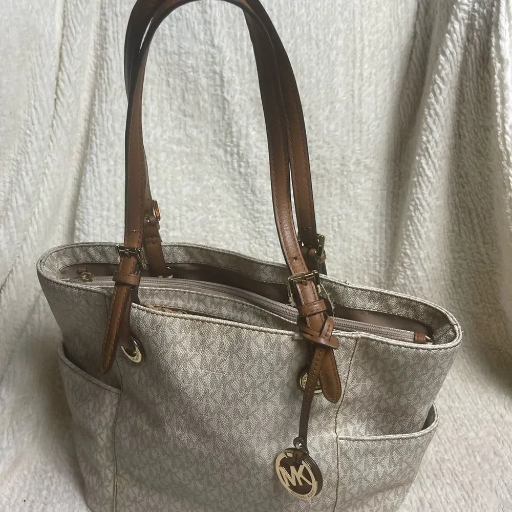 Michael Kors Beige signature Coated Canvas tote , tan leather straps .
